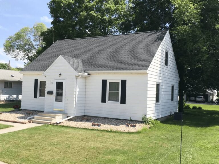 Newly installed dark gray asphalt shingle roof on white sided home in Oklahoma