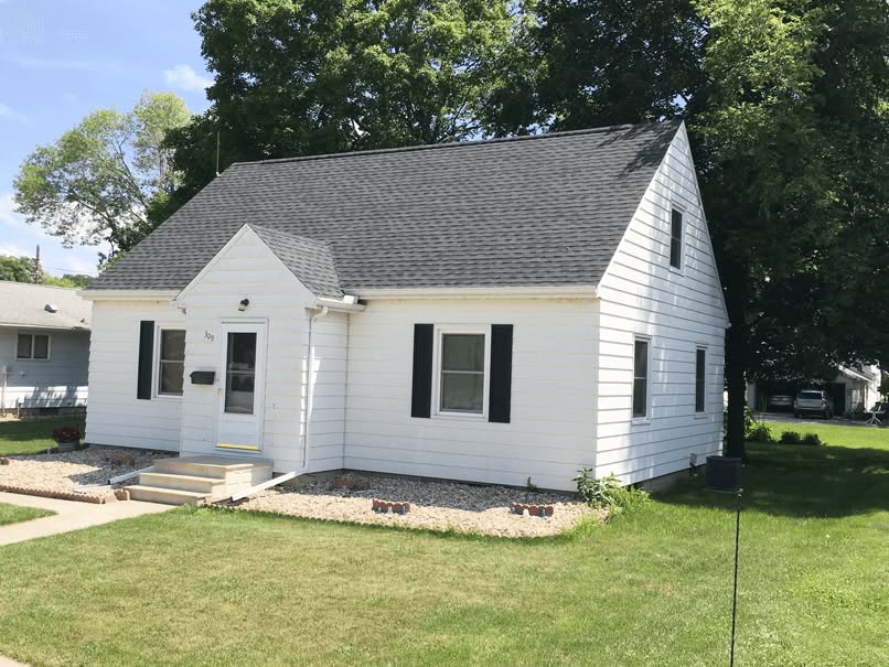 Newly installed dark gray asphalt shingle roof on white sided home in Oklahoma